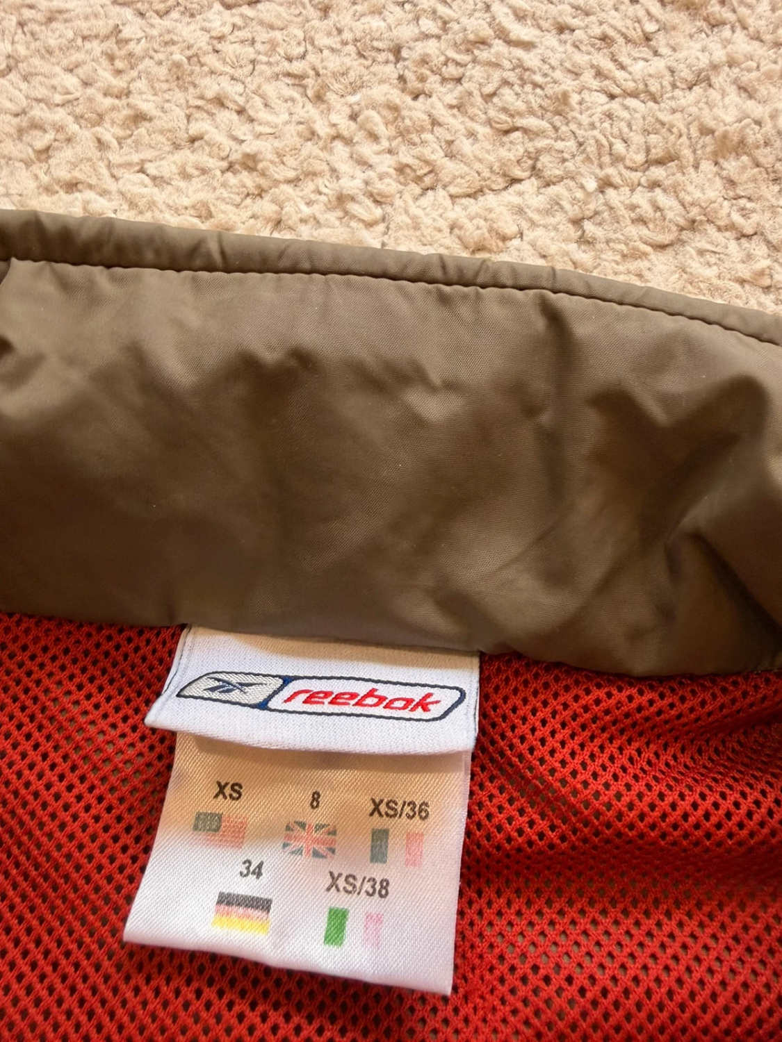 🤎 Veste Reebok Imperméable à Capuche Kaki - Protection & Style